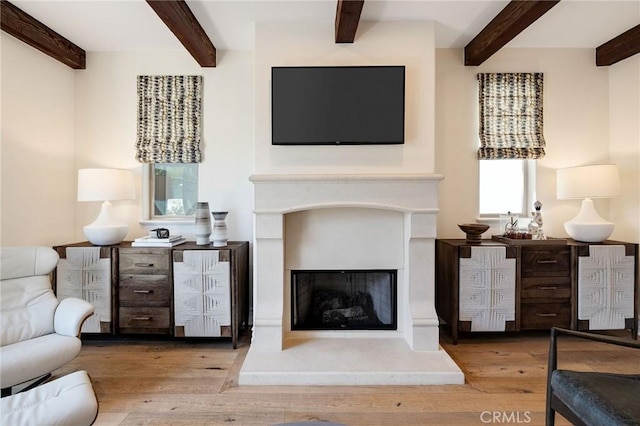 737 35th St, Manhattan Beach, CA 90266 - living room featuring beam ceiling, a fireplace with raised hearth, and wood finished floors