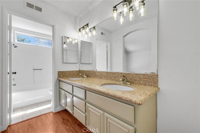 12820 Pan Am Blvd, Moreno Valley, CA 92553 - bathroom with double vanity, wood finished floors, and shower / bathtub combination