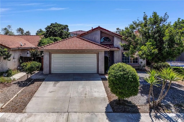 12820 Pan Am Blvd, Moreno Valley, CA 92553 - mediterranean / spanish-style home with stucco siding, driveway, an attached garage, and a tiled roof