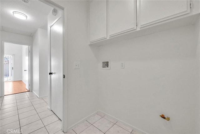 12820 Pan Am Blvd, Moreno Valley, CA 92553 - laundry room with light tile patterned floors, washer hookup, cabinet space, and baseboards