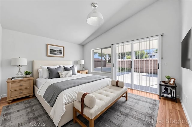 12820 Pan Am Blvd, Moreno Valley, CA 92553 - bedroom with access to exterior, wood finished floors, high vaulted ceiling, and baseboards