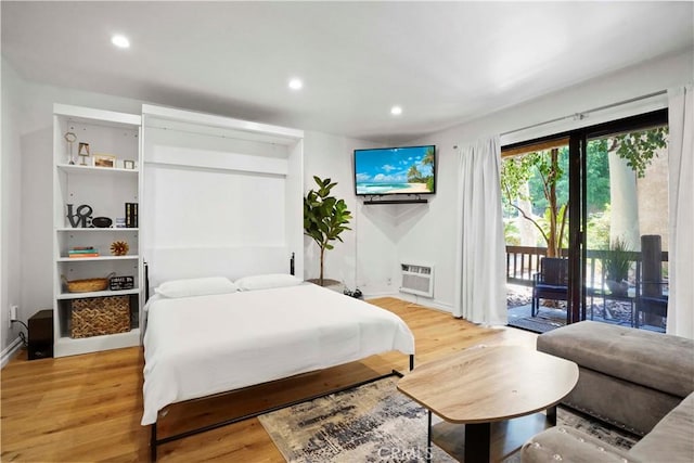 22100 Burbank Blvd Unit 150F, Woodland Hills, CA 91367 - bedroom with access to exterior, light wood finished floors, baseboards, recessed lighting, and an AC wall unit