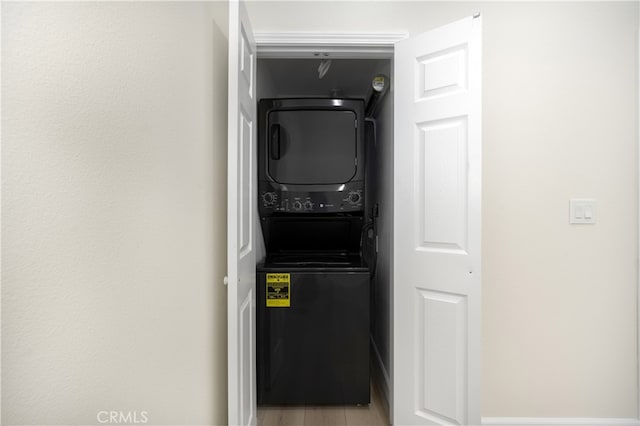laundry room with stacked washer and clothes dryer