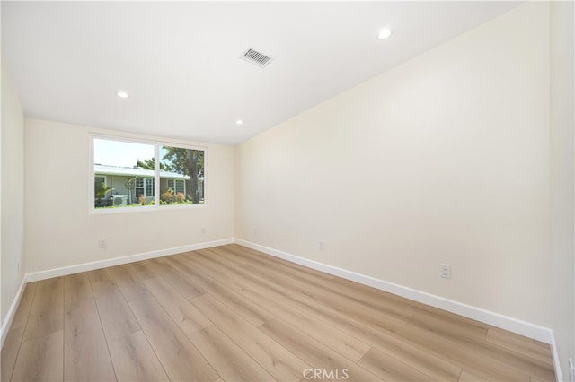unfurnished room with baseboards, light wood-style floors, and recessed lighting