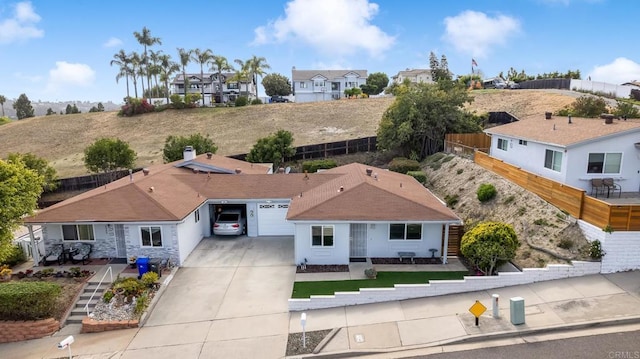 3317 Buena Hills Dr, Oceanside, CA 92056 - view of front of house featuring driveway, an attached garage, a residential view, and fence