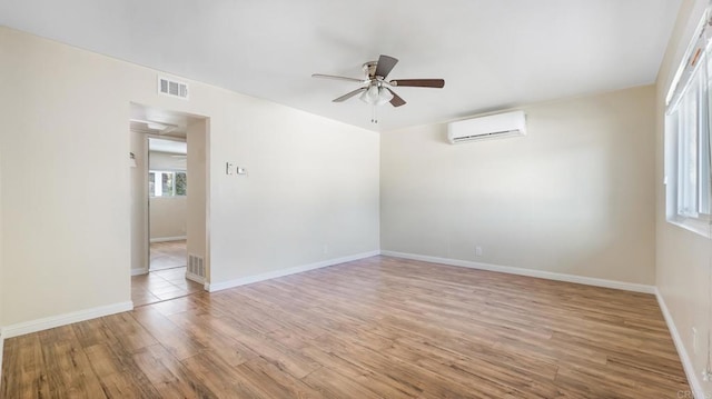 3317 Buena Hills Dr, Oceanside, CA 92056 - spare room with ceiling fan, a wall mounted air conditioner, wood finished floors, and baseboards