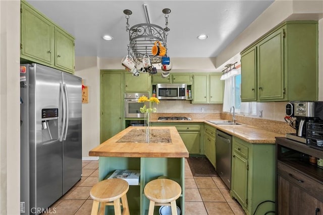 19853 Drasin Dr, Canyon Country, CA 91351 - kitchen with stainless steel appliances, a sink, light tile patterned floors, green cabinetry, and recessed lighting