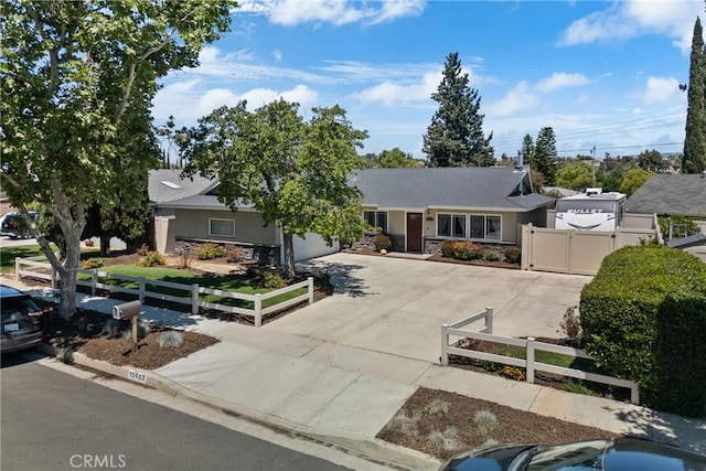19853 Drasin Dr, Canyon Country, CA 91351 - ranch-style house featuring concrete driveway, a fenced front yard, stone siding, a gate, and stucco siding