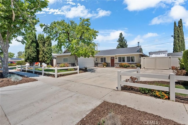 19853 Drasin Dr, Canyon Country, CA 91351 - view of front of property featuring an attached garage, concrete driveway, a fenced front yard, and stone siding