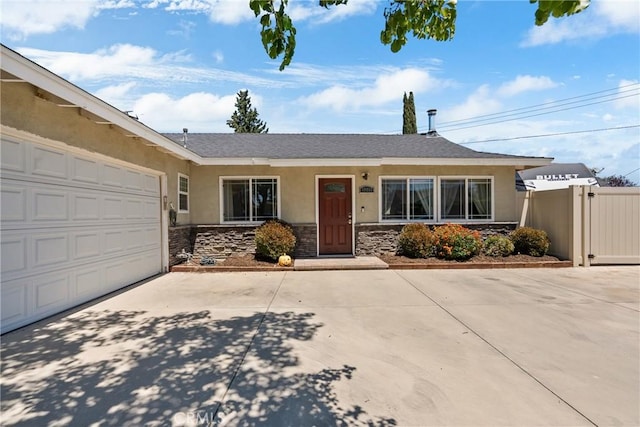 19853 Drasin Dr, Canyon Country, CA 91351 - view of front of home with stucco siding, stone siding, concrete driveway, fence, and a garage
