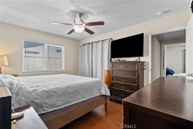 19853 Drasin Dr, Canyon Country, CA 91351 - bedroom with wood finished floors, a textured ceiling, a ceiling fan, and attic access