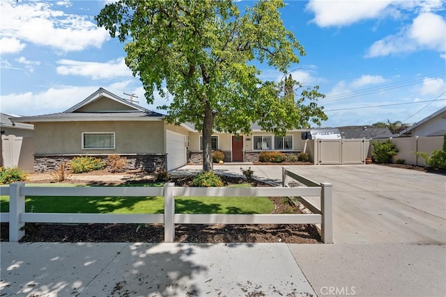 19853 Drasin Dr, Canyon Country, CA 91351 - ranch-style home with stucco siding, stone siding, an attached garage, a gate, and driveway