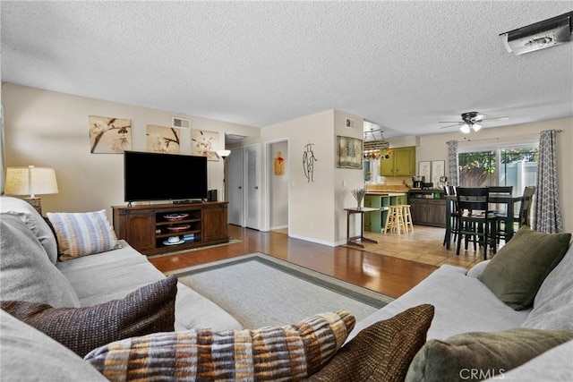 19853 Drasin Dr, Canyon Country, CA 91351 - living area featuring wood finished floors, a textured ceiling, ceiling fan, and baseboards