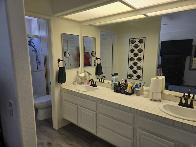 2521 Lynn Way, Vista, CA 92081 - bathroom with wood finished floors, double vanity, and toilet
