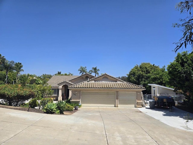 2521 Lynn Way, Vista, CA 92081 - view of front facade with concrete driveway, a garage, a tiled roof, and stucco siding
