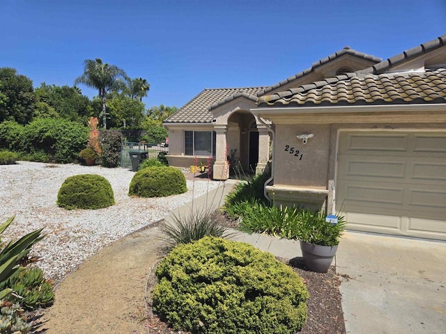 2521 Lynn Way, Vista, CA 92081 - mediterranean / spanish house with a garage, fence, a tile roof, and stucco siding