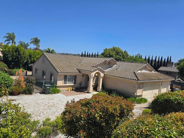 2521 Lynn Way, Vista, CA 92081 - view of front facade featuring an attached garage, a tiled roof, stucco siding, and fence