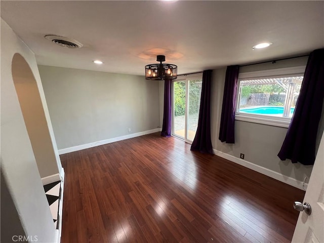 4073 Cedar St, Riverside, CA 92501 - empty room featuring a chandelier, dark wood-style floors, baseboards, and recessed lighting
