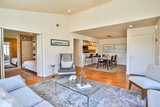 111 Greenfield, Irvine, CA 92614 - living area with light wood-type flooring, recessed lighting, baseboards, and lofted ceiling