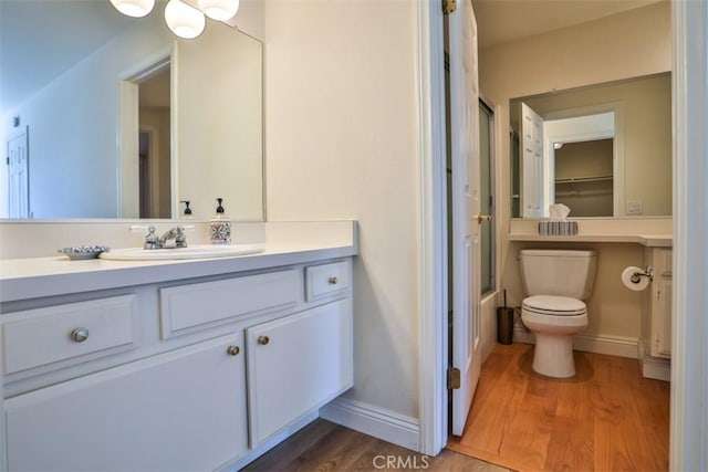111 Greenfield, Irvine, CA 92614 - bathroom with wood finished floors, vanity, baseboards, and toilet