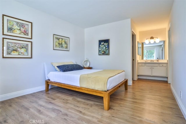 111 Greenfield, Irvine, CA 92614 - bedroom featuring light wood finished floors, baseboards, and ensuite bath