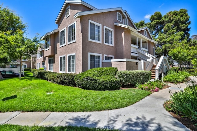 111 Greenfield, Irvine, CA 92614 - view of property exterior featuring stucco siding and a lawn