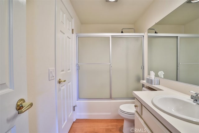 111 Greenfield, Irvine, CA 92614 - bathroom featuring wood finished floors, toilet, vanity, and enclosed tub / shower combo