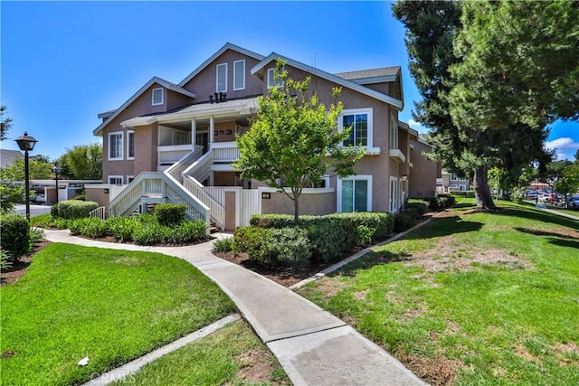 111 Greenfield, Irvine, CA 92614 - view of front facade with stairway, stucco siding, and a front yard