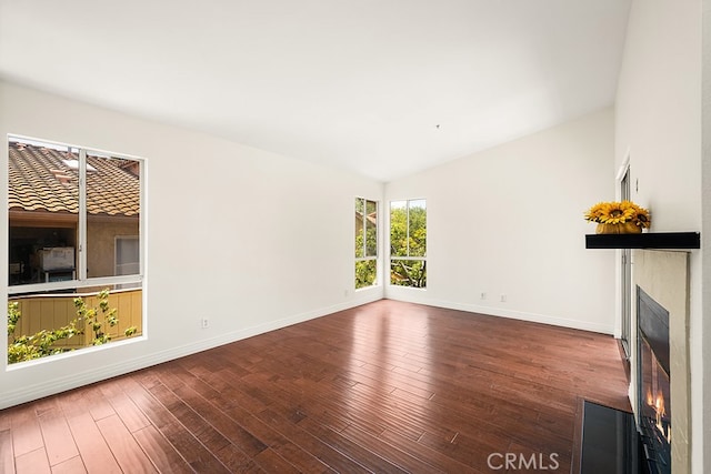 5140 Twilight Canyon Rd Unit 27H, Yorba Linda, CA 92887 - unfurnished living room featuring a fireplace with flush hearth, wood finished floors, baseboards, and lofted ceiling