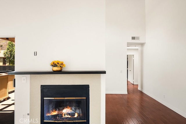 5140 Twilight Canyon Rd Unit 27H, Yorba Linda, CA 92887 - detailed view of a glass covered fireplace, wood finished floors, and baseboards