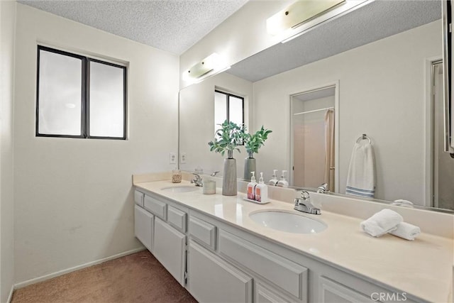 4141 Via Marisol Unit 215, Los Angeles, CA 90042 - full bath featuring double vanity, a shower, a textured ceiling, and baseboards