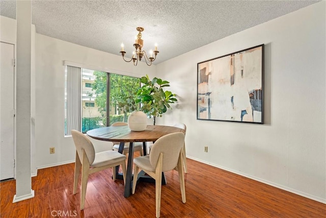 4141 Via Marisol Unit 215, Los Angeles, CA 90042 - dining area with a chandelier, a textured ceiling, baseboards, and wood finished floors