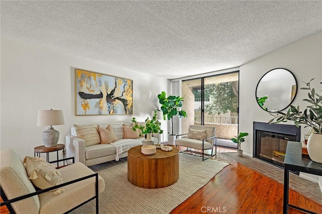 4141 Via Marisol Unit 215, Los Angeles, CA 90042 - living room with wood finished floors, a fireplace with flush hearth, and a textured ceiling