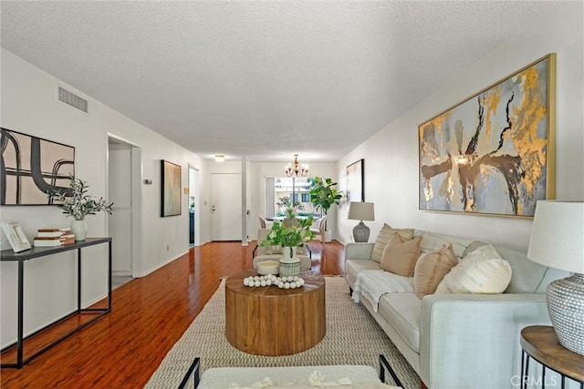 4141 Via Marisol Unit 215, Los Angeles, CA 90042 - living area featuring wood finished floors, a chandelier, and a textured ceiling