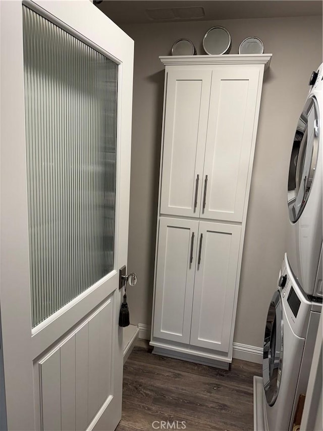 28185 Via Luis, Laguna Niguel, CA 92677 - clothes washing area featuring stacked washer / drying machine, dark wood finished floors, and baseboards