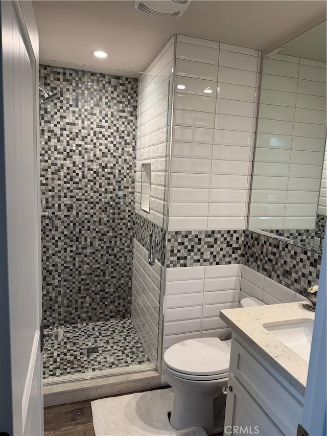 28185 Via Luis, Laguna Niguel, CA 92677 - full bathroom featuring a stall shower, toilet, tile walls, recessed lighting, and vanity