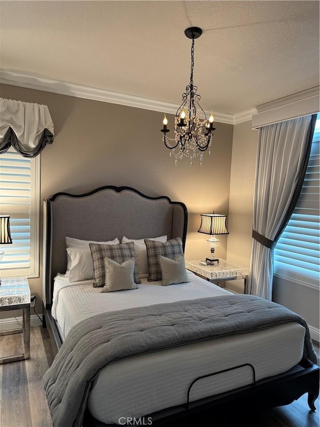 28185 Via Luis, Laguna Niguel, CA 92677 - bedroom with a chandelier, dark wood-type flooring, ornamental molding, and baseboards