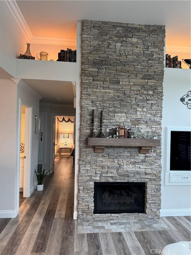 28185 Via Luis, Laguna Niguel, CA 92677 - unfurnished living room featuring ornamental molding, baseboards, wood finished floors, and a stone fireplace