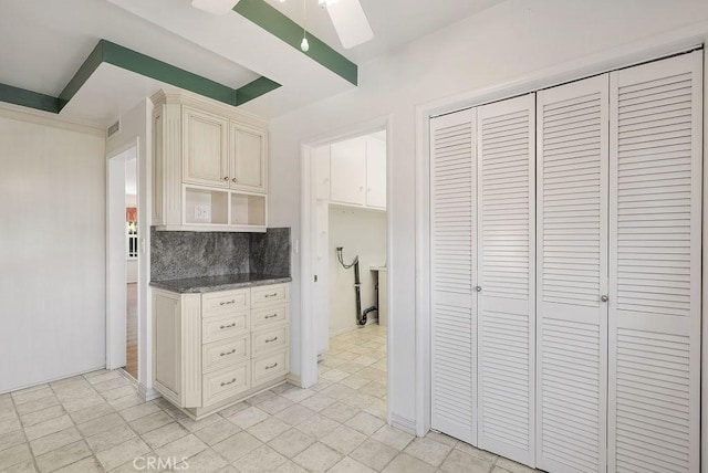 338 S La Serena Dr, West Covina, CA 91791 - kitchen featuring a skylight, tasteful backsplash, cream cabinets, dark stone counters, and baseboards
