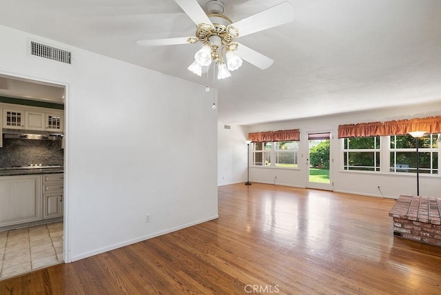 338 S La Serena Dr, West Covina, CA 91791 - unfurnished living room featuring light wood-style floors, a ceiling fan, and baseboards