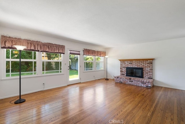 338 S La Serena Dr, West Covina, CA 91791 - unfurnished living room with wood finished floors, a fireplace, and baseboards