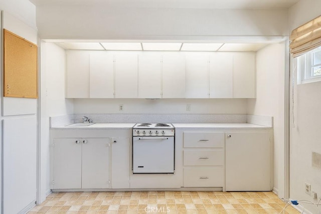 338 S La Serena Dr, West Covina, CA 91791 - kitchen with white range with electric cooktop, light countertops, a sink, and white cabinets