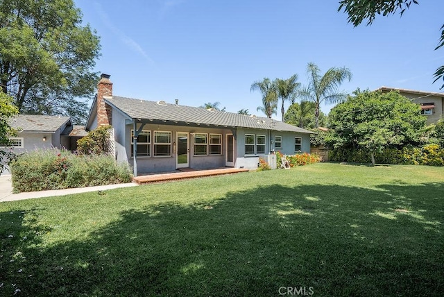 338 S La Serena Dr, West Covina, CA 91791 - back of property featuring a yard, a chimney, and stucco siding