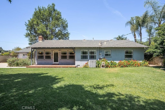338 S La Serena Dr, West Covina, CA 91791 - back of house featuring stucco siding, a chimney, and a lawn