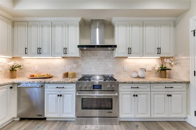 415 California St Unit D, Arcadia, CA 91006 - kitchen with appliances with stainless steel finishes, wall chimney exhaust hood, white cabinets, light wood finished floors, and tasteful backsplash