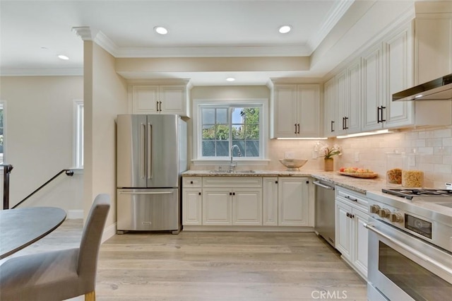 415 California St Unit D, Arcadia, CA 91006 - kitchen with stainless steel appliances, a sink, wall chimney exhaust hood, light wood-style floors, and backsplash