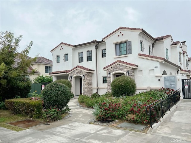 415 California St Unit D, Arcadia, CA 91006 - mediterranean / spanish-style house featuring a tile roof, stucco siding, and stone siding
