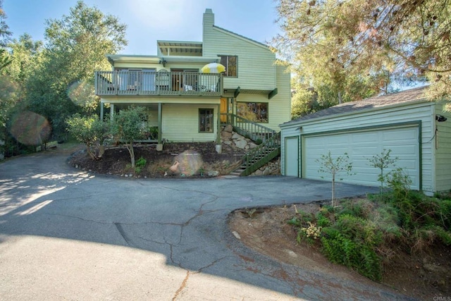 28330 Meadow Glen Way W, Escondido, CA 92026 - view of front facade featuring stairs, a balcony, a garage, and a chimney