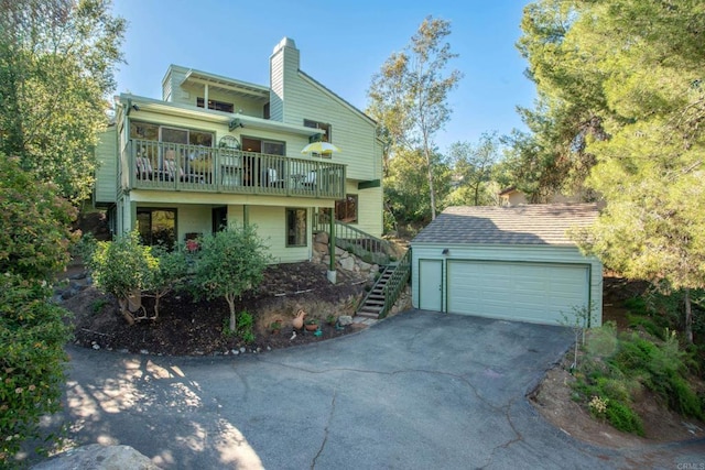 28330 Meadow Glen Way W, Escondido, CA 92026 - view of front of house with a chimney, stairs, a garage, and an outbuilding