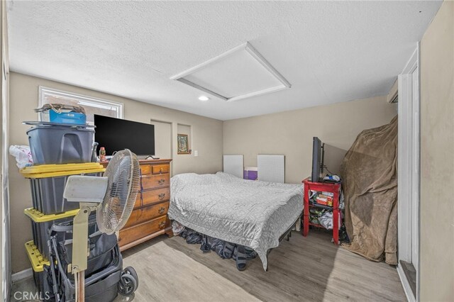 1709 S Townsend St, Santa Ana, CA 92704 - bedroom with attic access, wood finished floors, a textured ceiling, and recessed lighting